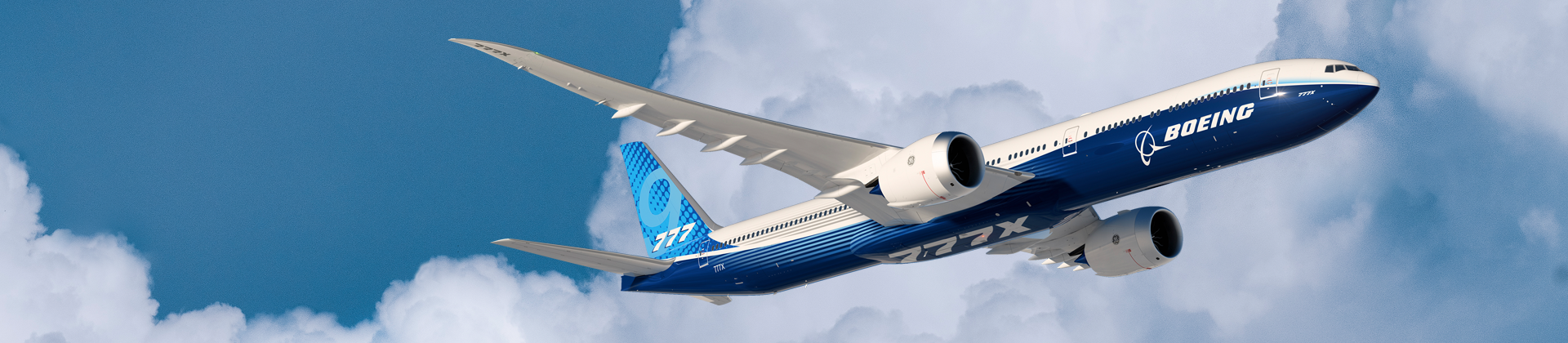 777X in flight with clouds in the background.